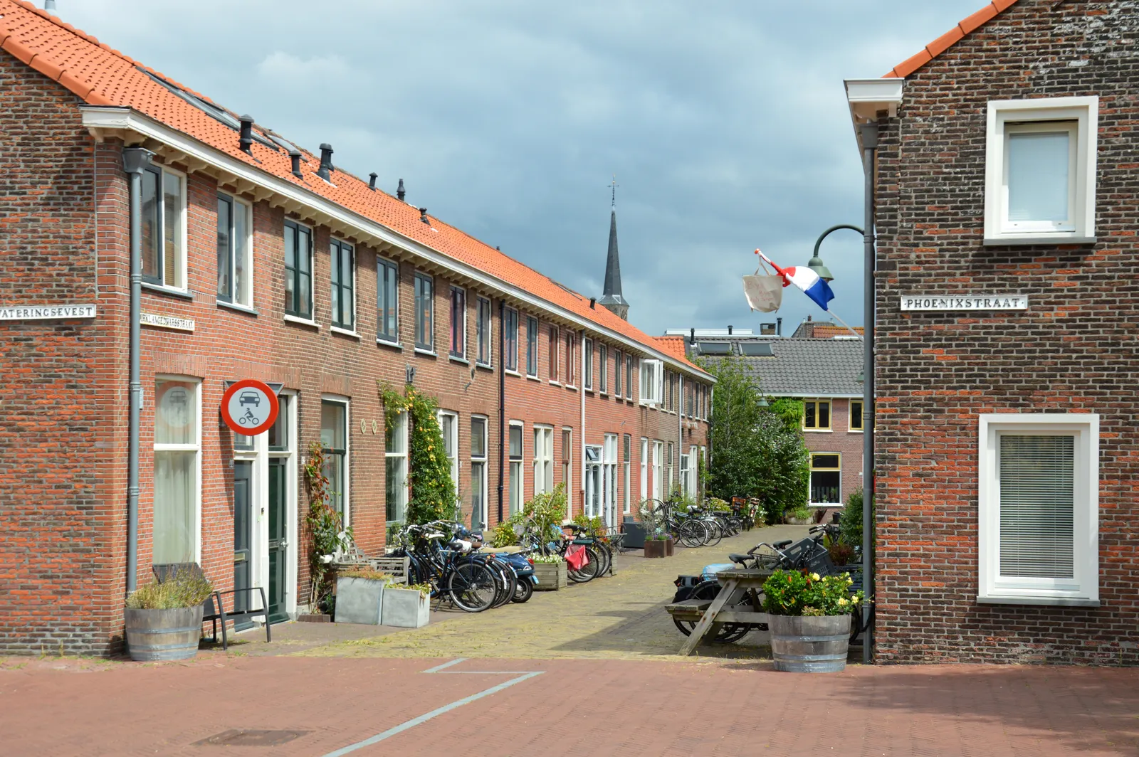 Rijtjeshuizen met rode dakpannen in Delft; een aangehouden eigen woning in Nederland valt na emigratie in box 3